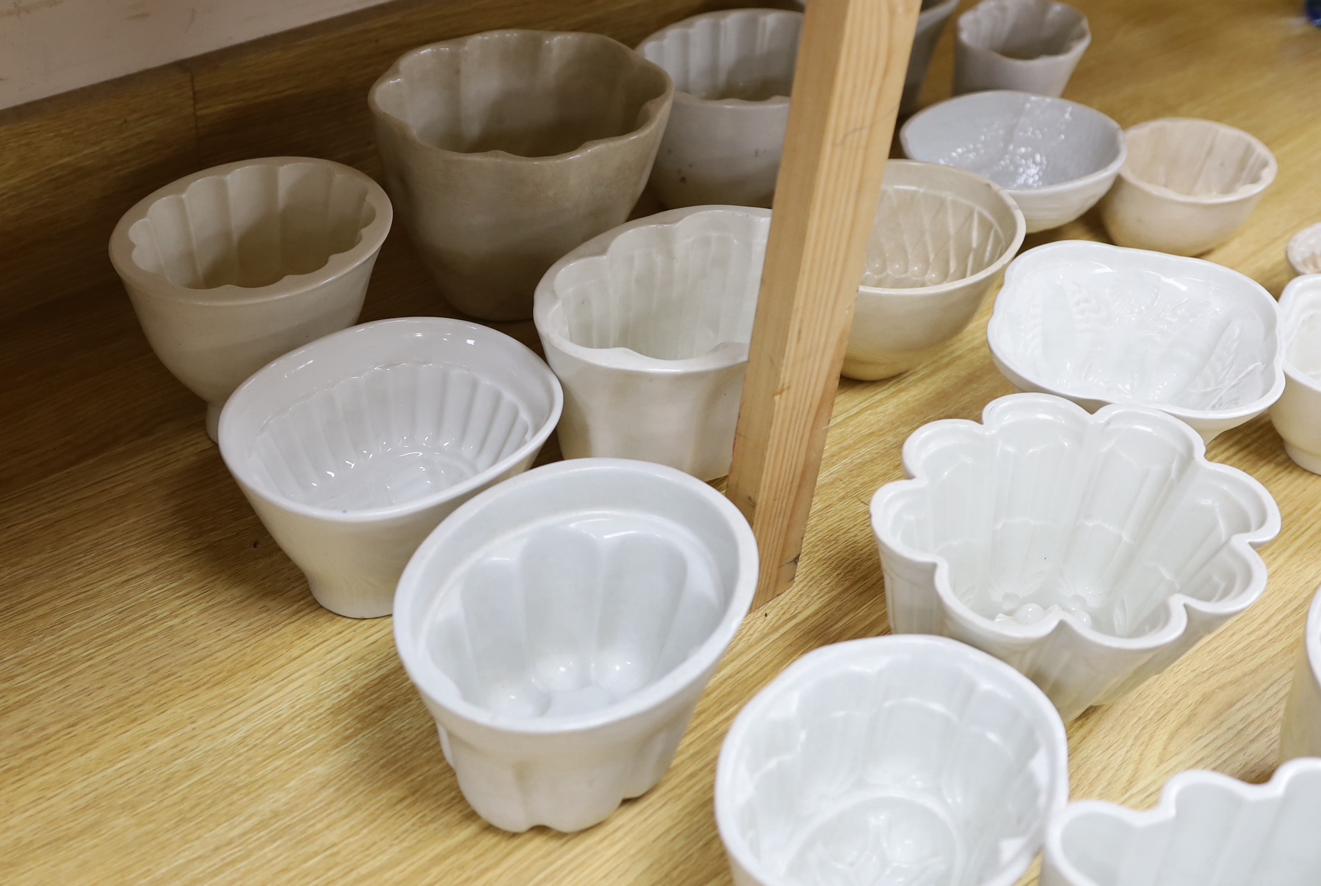 Eighteen white ceramic jelly moulds, examples, by Booth, Adams, Shelley, Greens, etc. tallest 14cm